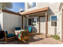 Small patio with seating area located at the townhome's entrance at 954 E Diamond Dr, Tempe, AZ 85283