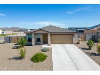 Single-story house with a two-car garage and desert landscaping at 10366 W Camelia Dr, Arizona City, AZ 85123