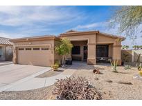 Single-story home with desert landscaping, two-car garage, and covered entryway at 17581 W Canyon Ln, Goodyear, AZ 85338