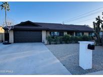 Ranch style home with a two-car garage and mature landscaping at 2401 E Christy Dr, Phoenix, AZ 85028