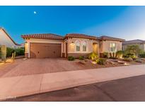 Single-story home with a brick driveway and desert landscaping at 26647 W Covey Ln, Buckeye, AZ 85396