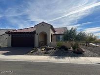 Single-story home with a two-car garage and desert landscaping at 26861 W Adam Ave, Buckeye, AZ 85396