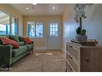 Bright living room with green couch and wood floors at 280 E Morelos St, Chandler, AZ 85225