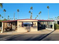 Tan single-wide manufactured home with carport and covered patio at 3104 E Broadway -- # 88, Mesa, AZ 85204