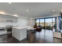 Bright, open living room with modern kitchen, dark wood floors and sliding doors to a balcony at 4422 N 75Th St # 3012, Scottsdale, AZ 85251