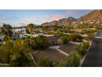 Aerial view of a house with a large backyard, mountain views, and a paved driveway at 4450 N 54Th St, Phoenix, AZ 85018