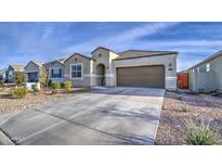 Charming single-story home with a well-manicured yard and a spacious two-car garage at 5267 E Diatomite Dr, San Tan Valley, AZ 85143