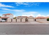 Desert home features a tile roof, a two car garage and gated, private front courtyard at 5421 W Brown St, Glendale, AZ 85302