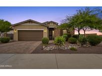 Single-story home with a two-car garage and landscaped front yard at 7635 W Rock Springs Dr, Peoria, AZ 85383