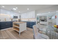 Modern kitchen boasts updated appliances and an island with seating at 8413 E Sheridan St, Scottsdale, AZ 85257