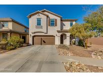 Two-story home with a two-car garage and a well-maintained front yard featuring desert landscaping at 852 E Gary Ln, Phoenix, AZ 85042