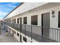 Exterior view of apartment building with walkway and railings at 18202 N Cave Creek Rd # 241, Phoenix, AZ 85032