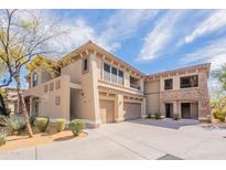 Beautiful multi-level home with stone accents, desert landscaping, and a private two-car garage at 19700 N 76Th St # 2072, Scottsdale, AZ 85255
