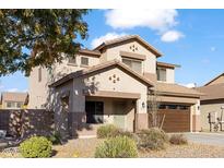 Charming two-story home with a well-maintained front yard and attached two car garage at 44250 W Vineyard St, Maricopa, AZ 85139