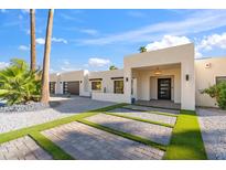 Modern home exterior with landscaped yard and two-car garage at 5719 E Sweetwater Ave, Scottsdale, AZ 85254