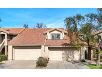 Tan two-story condo with two-car garage and mature landscaping at 11515 N 91 St # 238, Scottsdale, AZ 85260