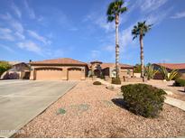 Single-story home with three-car garage and desert landscaping at 11722 E Starflower Dr, Chandler, AZ 85249