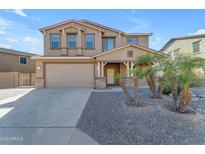 Two-story house with a three-car garage and desert landscaping at 1179 E Coyote Creek Way, San Tan Valley, AZ 85143