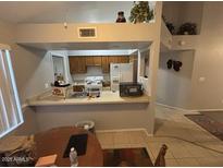 Bright kitchen features ample counter space and wood cabinets at 1240 W Straford Dr, Chandler, AZ 85224