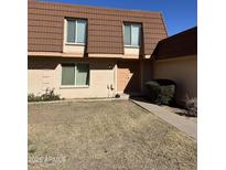 Tan brick condo with brown tile roof, landscaping, and walkway at 1631 E Dunbar Dr, Tempe, AZ 85282