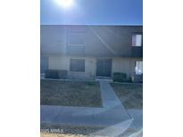 Tan two-story condo with gray roof, double doors, and small front yard at 1706 E Dunbar Dr, Tempe, AZ 85282