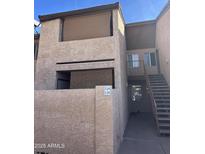 Two-story condo building with stucco exterior and private balcony at 1942 S Emerson St # 226, Mesa, AZ 85210