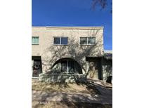 Tan stucco townhouse exterior with arched entryway and small front yard at 225 N Standage St # 5, Mesa, AZ 85201