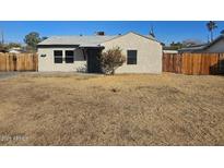 Cozy single-story home with a neutral-toned exterior and a well-kept front yard at 2324 W Luke Ave, Phoenix, AZ 85015