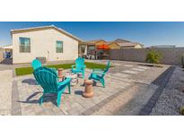 Relaxing backyard with a fire pit and artificial turf at 2427 W Kowalsky Ln, Phoenix, AZ 85041