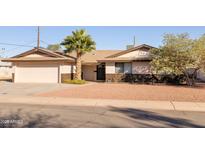 Single story home with attached garage and desert landscaping at 2715 S Rita Ln, Tempe, AZ 85282