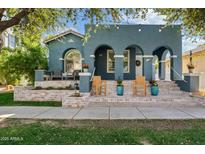 Charming blue home with arched porch, brick accents, and welcoming curb appeal at 3021 E Agritopia N Loop, Gilbert, AZ 85296