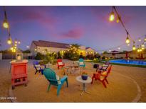 Inviting backyard with firepit, string lights, and colorful seating at 30416 N 64Th St, Cave Creek, AZ 85331