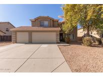 Two-story house with a three-car garage and landscaped front yard at 31292 N Candlewood Dr, San Tan Valley, AZ 85143