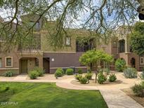 Charming two-story townhome featuring well-maintained landscaping and inviting curb appeal at 3935 E Rough Rider Rd # 1191, Phoenix, AZ 85050