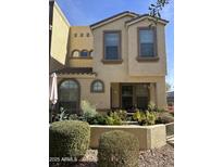 Tan two-story townhome with arched windows and landscaping at 6710 E University Dr # 117, Mesa, AZ 85205