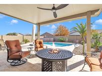 Relaxing backyard oasis with a sparkling pool and fire pit at 789 E Blossom Rd, San Tan Valley, AZ 85143