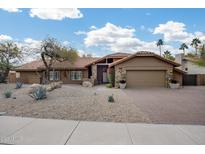 Charming single-story home with a tile roof, desert landscaping, and a brick-paved driveway leading to an attached two-car garage at 9837 E Pershing Ave, Scottsdale, AZ 85260