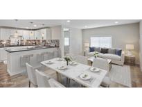 Open-concept living space with modern kitchen, dining area, and comfortable living room featuring bright natural light at 104 N 114Th St, Apache Junction, AZ 85120