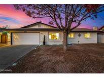 Charming single-story home featuring a well-maintained yard, covered entryway, and attached garage at 1708 W Harmont Dr, Phoenix, AZ 85021