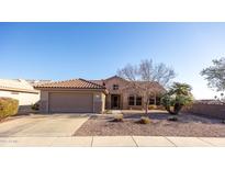 Single-story home with a terracotta tile roof and attached two-car garage at 18603 N Twilight Way, Surprise, AZ 85374