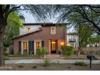 Charming two-story home with brick accents, manicured landscaping, and inviting curb appeal at 20653 N 101St St, Scottsdale, AZ 85255