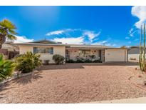 Charming single-story home with low-maintenance desert landscaping and attached garage at 5433 E Dodge St, Mesa, AZ 85205