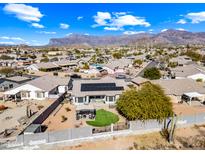 Expansive aerial view of a property with desert landscaping, solar panels, and mountain views at 8479 E Sunrise Sky Dr, Gold Canyon, AZ 85118