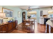 Charming dining area with wood table and hardwood floors at 9613 W Long Hills Dr, Sun City, AZ 85351