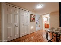 Bright hallway with wood floors, leading to bathroom and closets at 10330 W Thunderbird Blvd # A321, Sun City, AZ 85351