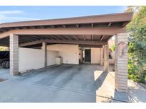 Tan home with covered parking, decorative bricks, and desert landscaping at 1245 E Avenida Hermosa --, Phoenix, AZ 85014