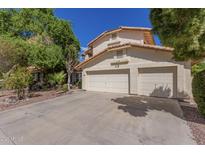 Two story home featuring a three car garage and a well maintained driveway at 1450 W Sea Haze Dr, Gilbert, AZ 85233