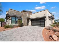 Craftsman style home with stone accents and a 3-car garage at 15957 E Ridgestone Dr, Fountain Hills, AZ 85268