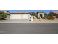 Single-story home with a two-car garage and desert landscaping at 16442 W Quarry Ct, Surprise, AZ 85374