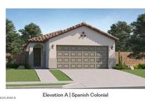 Spanish-style home with a two-car garage and landscaped lawn at 17500 N Toledo Ave, Maricopa, AZ 85138